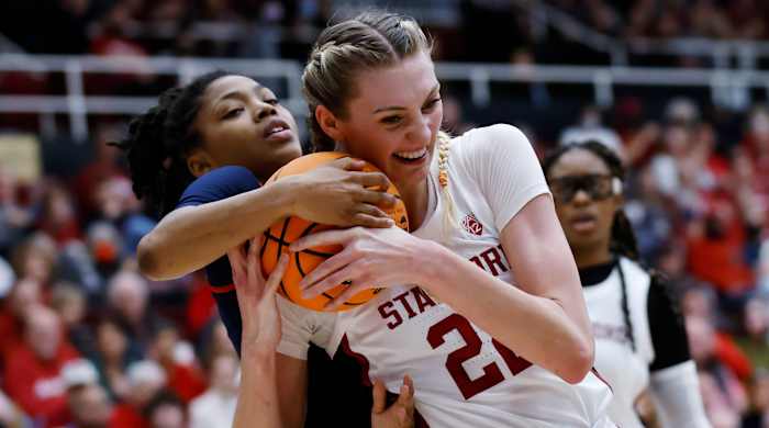 Mississippi guard Angel Baker and Stanford forward Cameron Brink  vie for the ball in the second round of the NCAA women’s tournament.